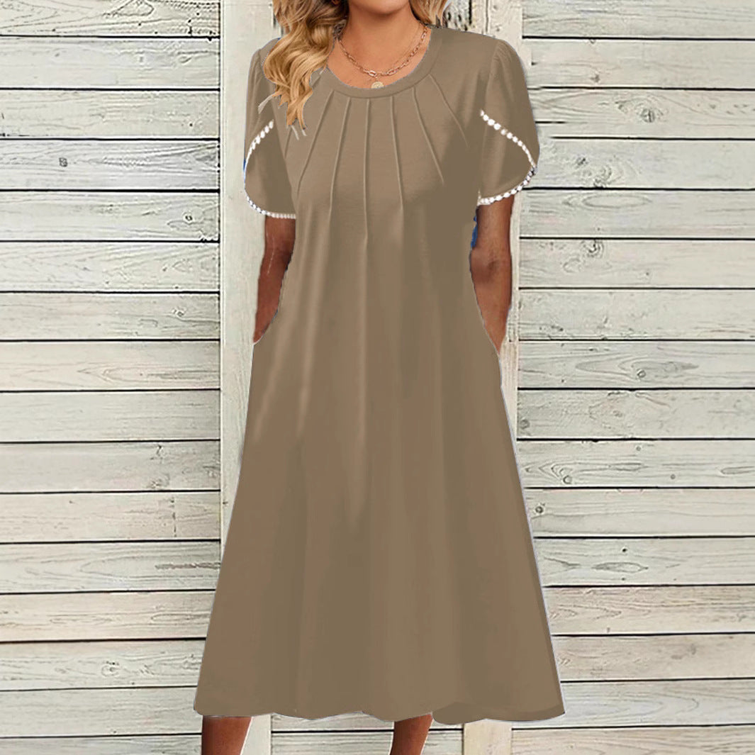 Dame fritidskjole med elegante draperinger og praktiske lommer Stilla