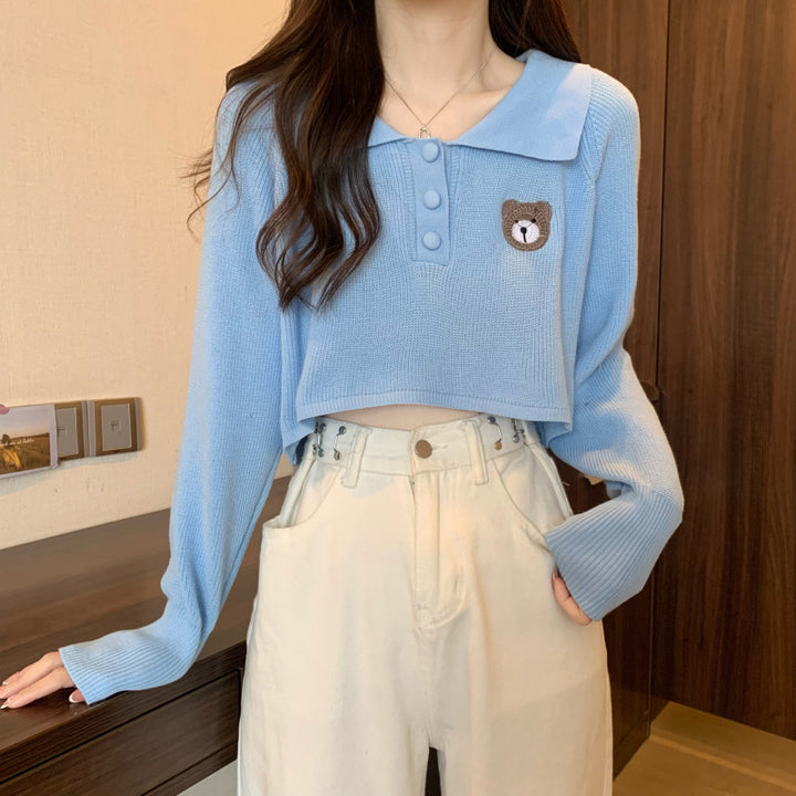 Kvinder Cropped Pullover med en knaplukning og unicorn emblem