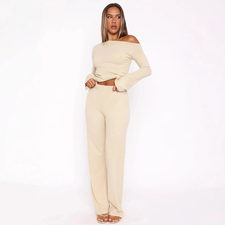 Dame stilfuld strik ensemble med asymmetrisk top og bred ben