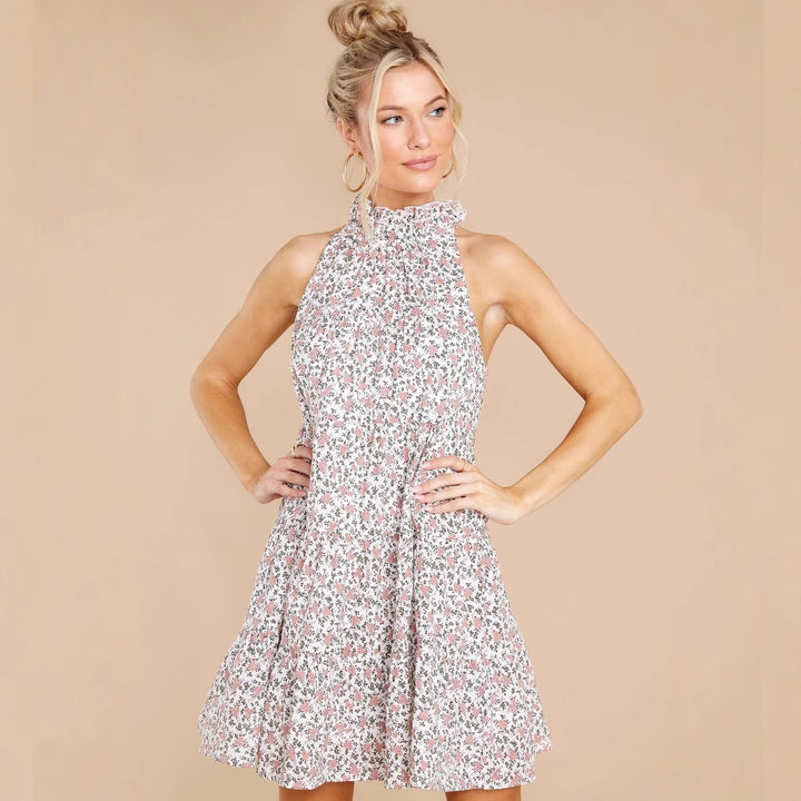 Women's halter dress with playful floral design and ruffle details