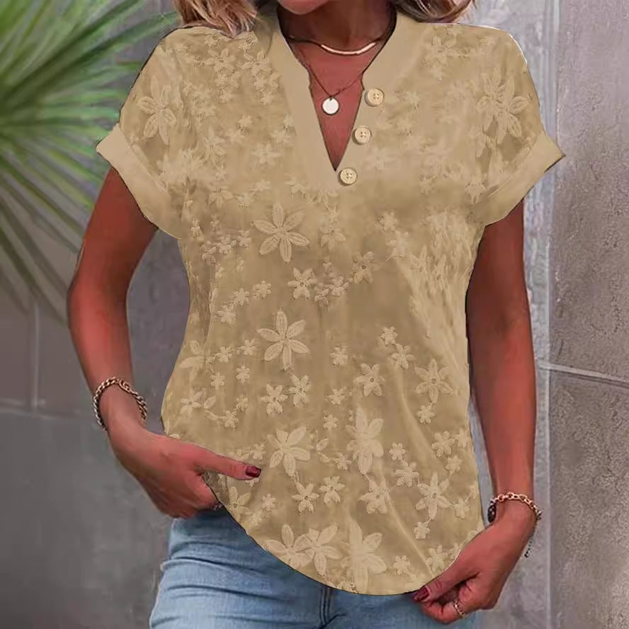 Damebluse med feminint blomsterbroderi-mønster Stilla