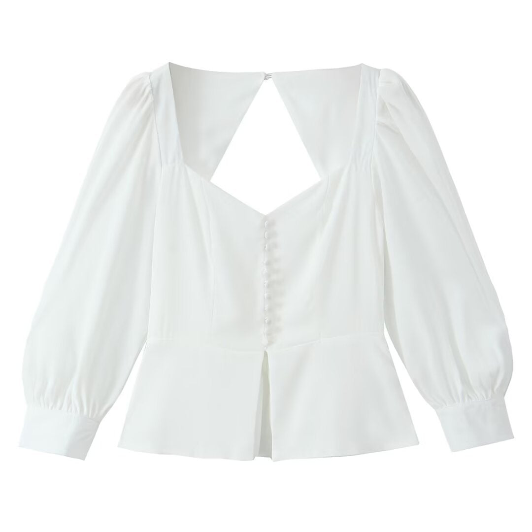 Damebluse med raffinerede puffærmer og elegant rygudskæring Stilla