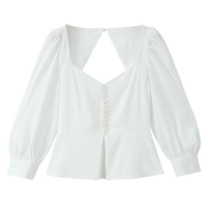Damebluse med raffinerede puffærmer og elegant rygudskæring Stilla