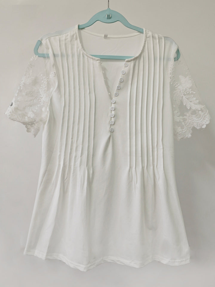 Damebluse med spidse detaljer og plissering Stilla