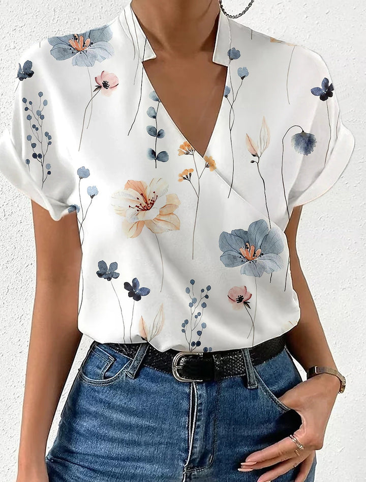 Damebluse med floralt design og moderne V-udskæring Stilla