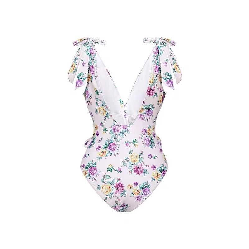 Dame heldragt badedragt med floralsk design og elegant omslagsskørt Stilla