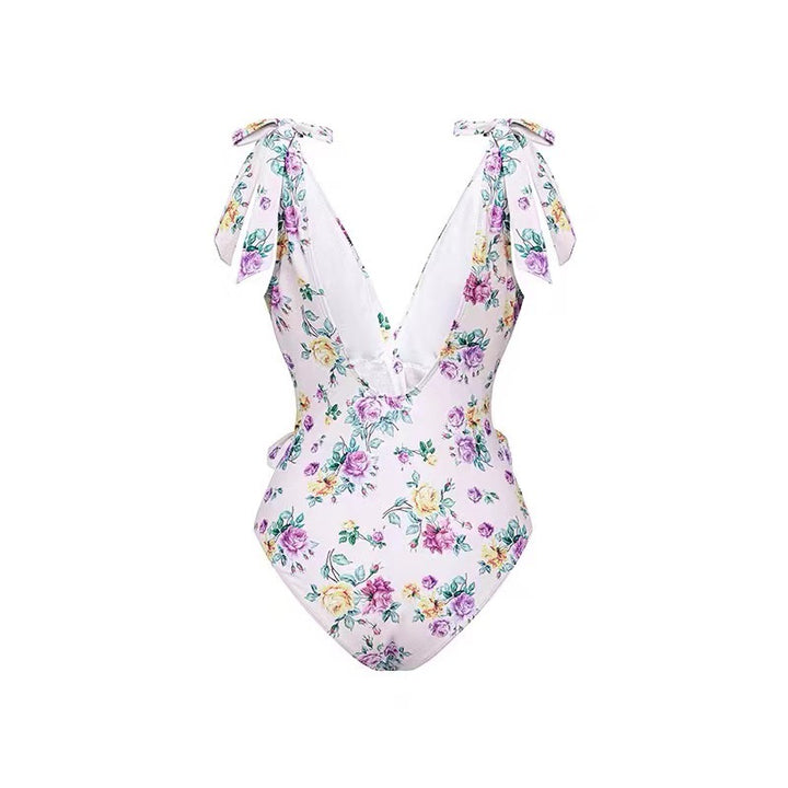 Dame heldragt badedragt med floralsk design og elegant omslagsskørt Stilla