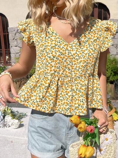 Dame blusetop med voluminøse flæsedetaljer og blomsterdesign Stilla
