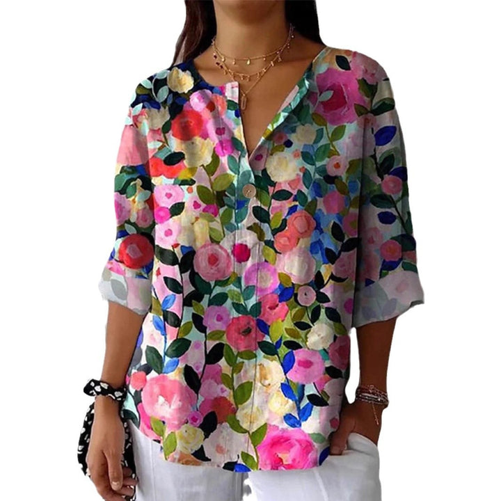 Damebluse med blomsterdesign og knaplukning Stilla