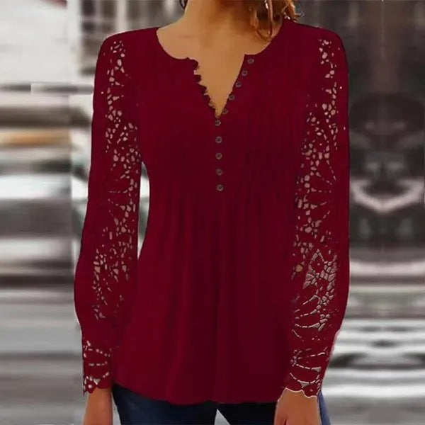 Damer spidsbluse med elegante knapdetaljer og voluminøse ærmer Stilla