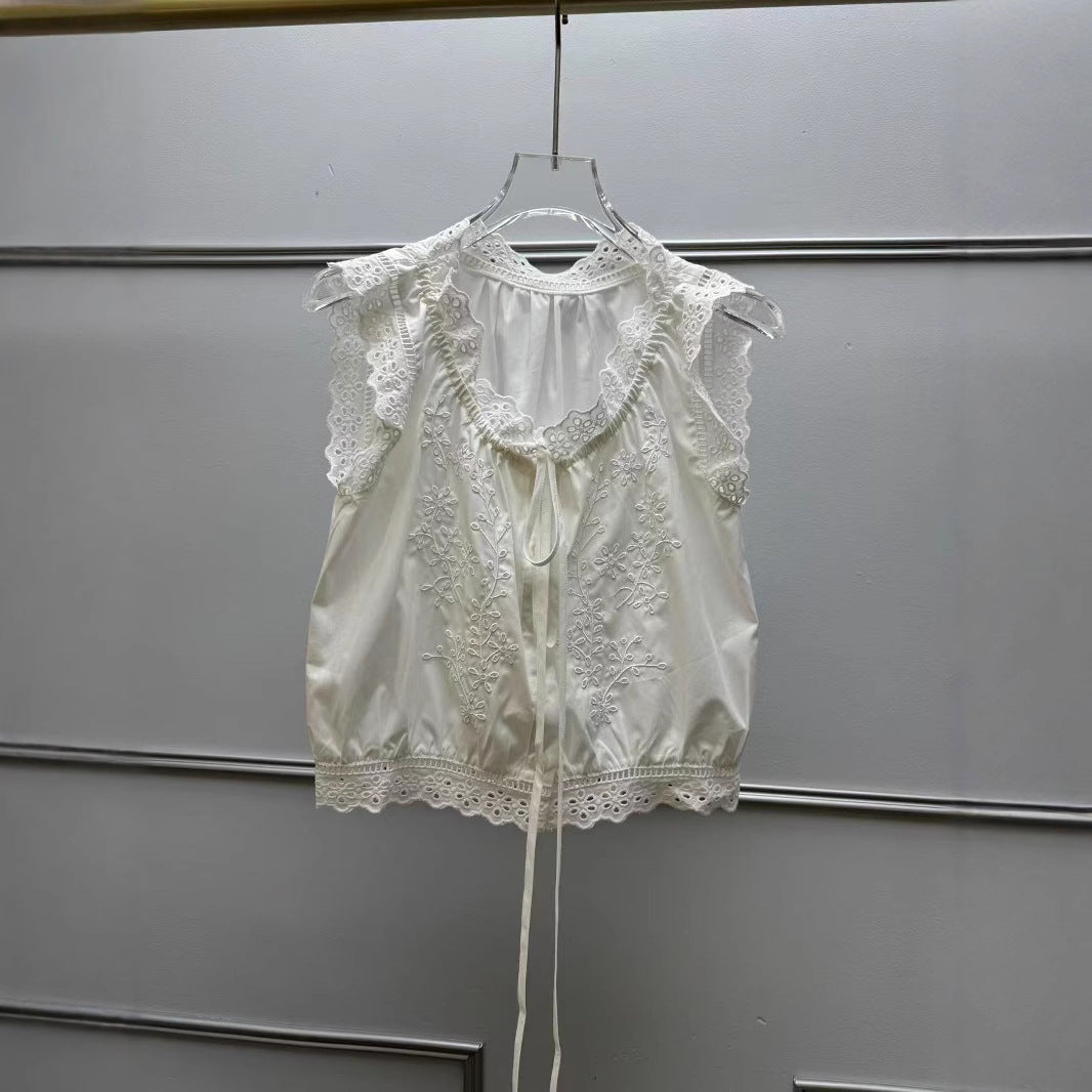 Damebluse med sarte spidsdetaljer og floralt broderidesign Stilla