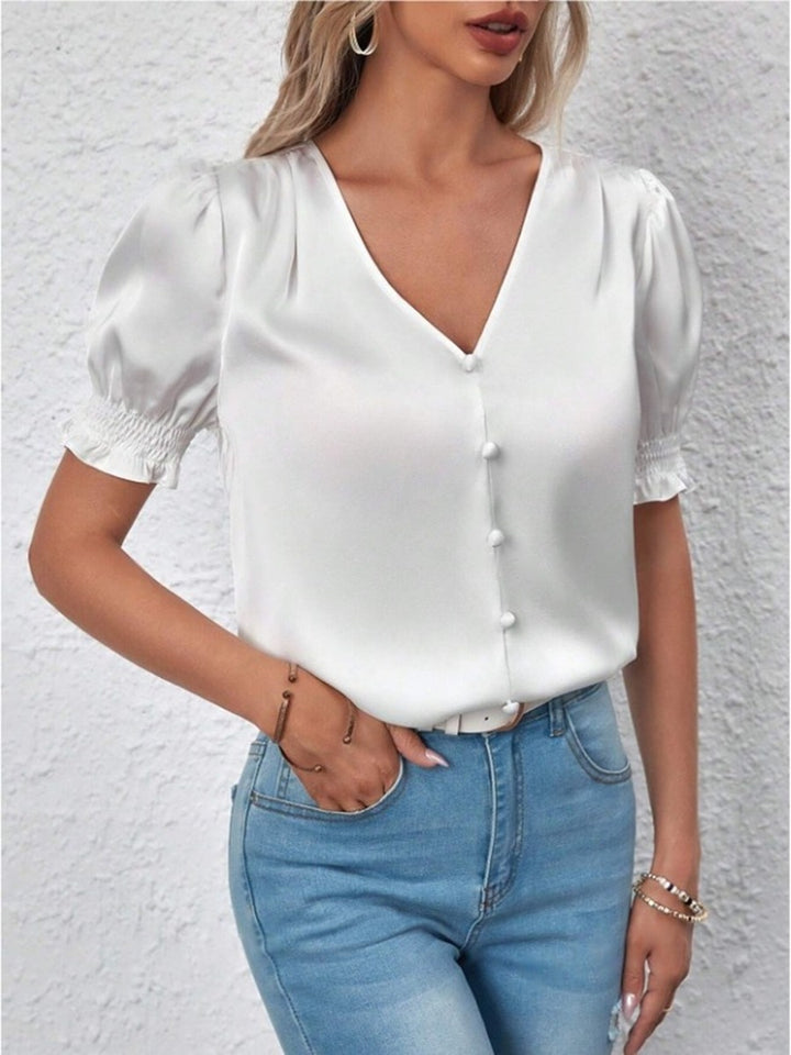 Dame satinbluse med puffærmer og elegant knaplukning Skovae