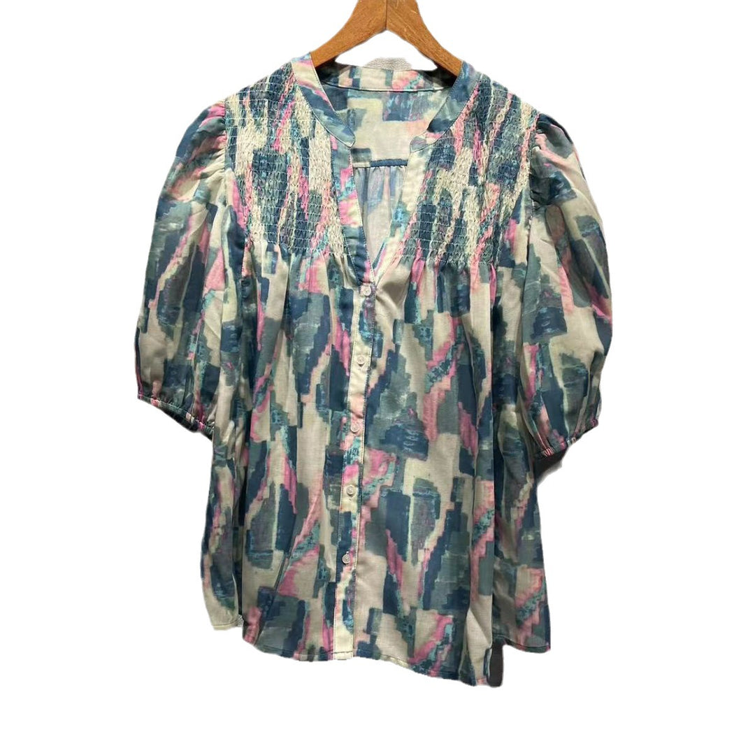 Damebluse med voluminøse puffærmer og raffineret smockdesign Stilla