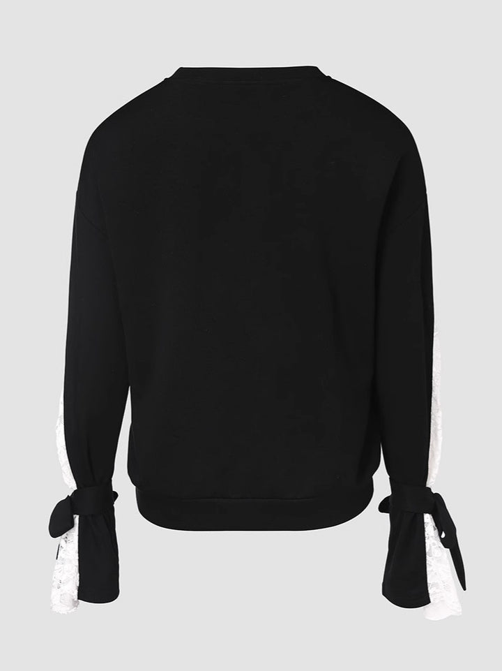 Dame top med elegante spids ærmer og fashionable detaljer Stilla