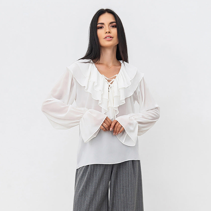 Damebluse med volantdesign og glitrende ærmer Stilla