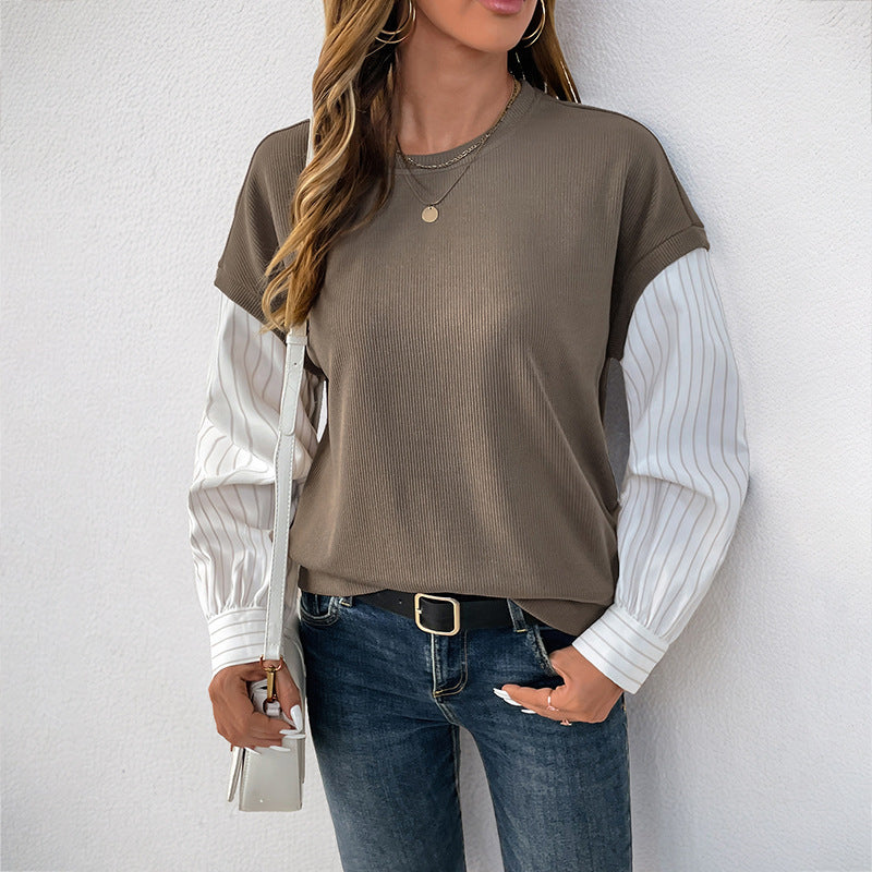 Dames fashionabel top med kreativ lagdelt look og elegante rullede ærmer Stilla