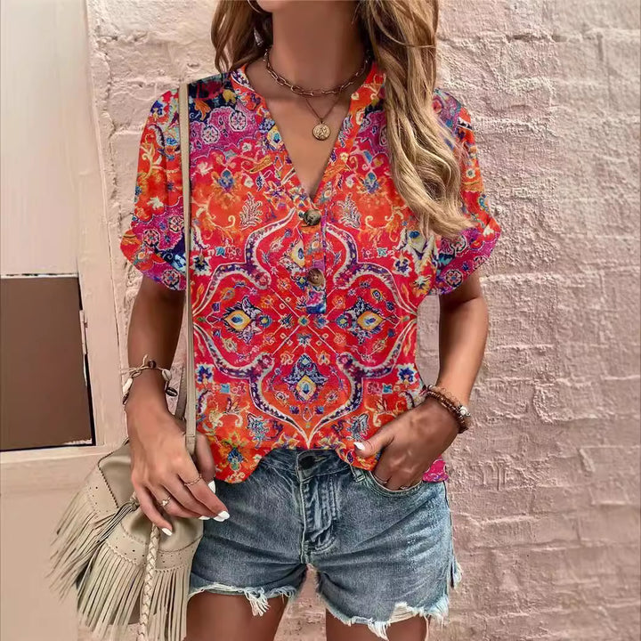 Damebluse med blomsterdesign og knaplukning Stilla