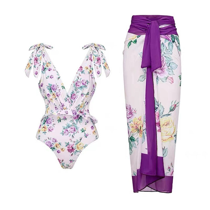 Dame heldragt badedragt med floralsk design og elegant omslagsskørt Stilla