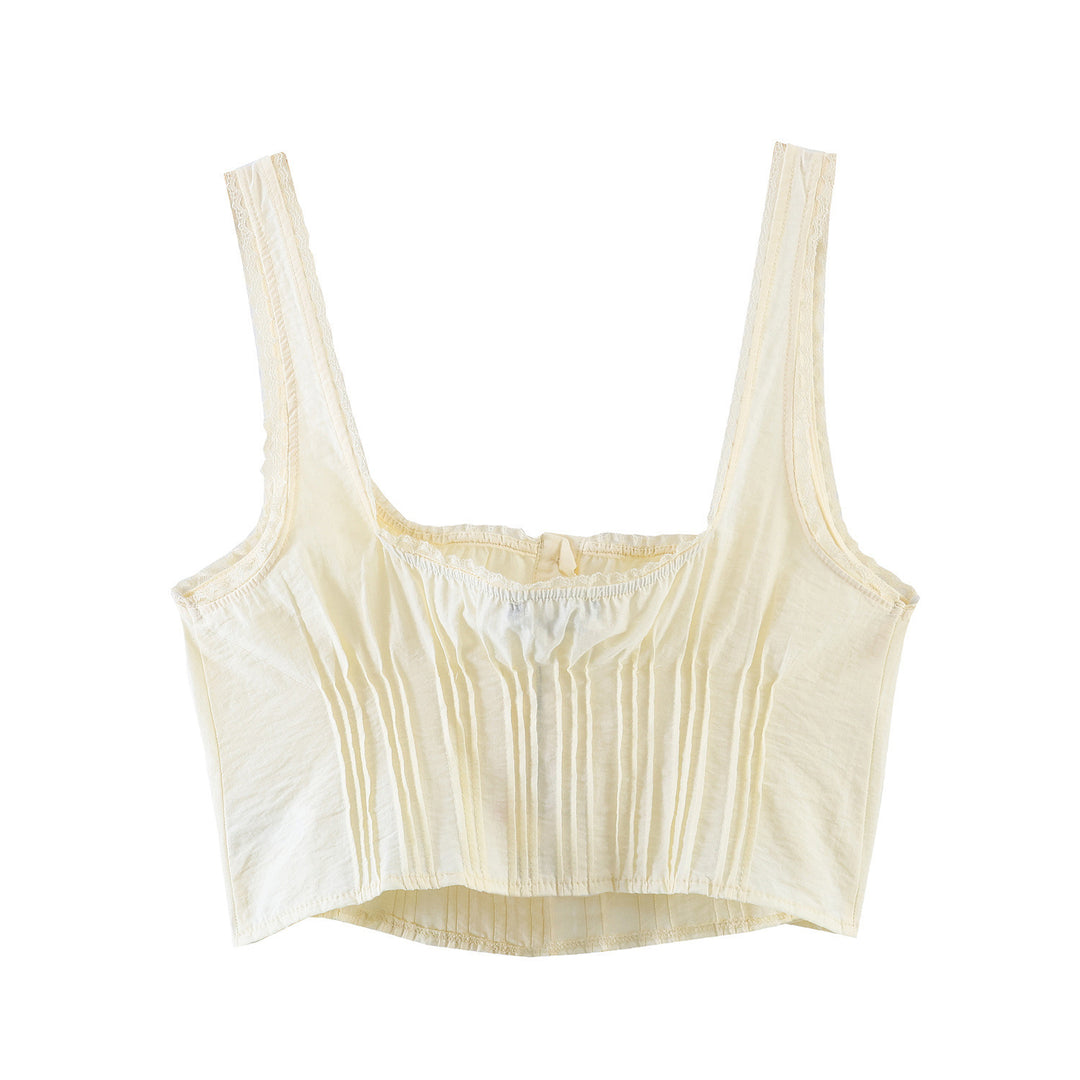 Dame-crop-top med fine folder og dekorknapper Skovae