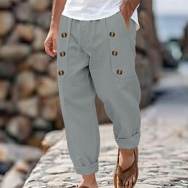 Herren nan loose linen pants with decorative button stripes, rolled ankle hem and side pockets Skovae