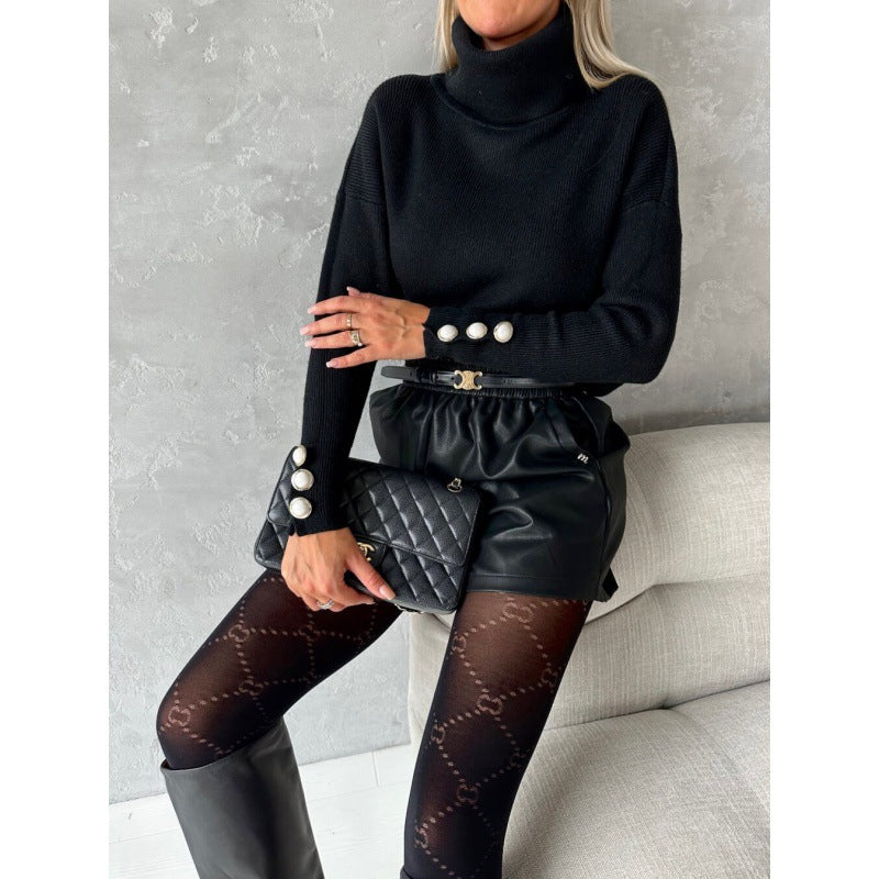 Dame rullekravepullover med dekorative knapper og bred pasform Stilla