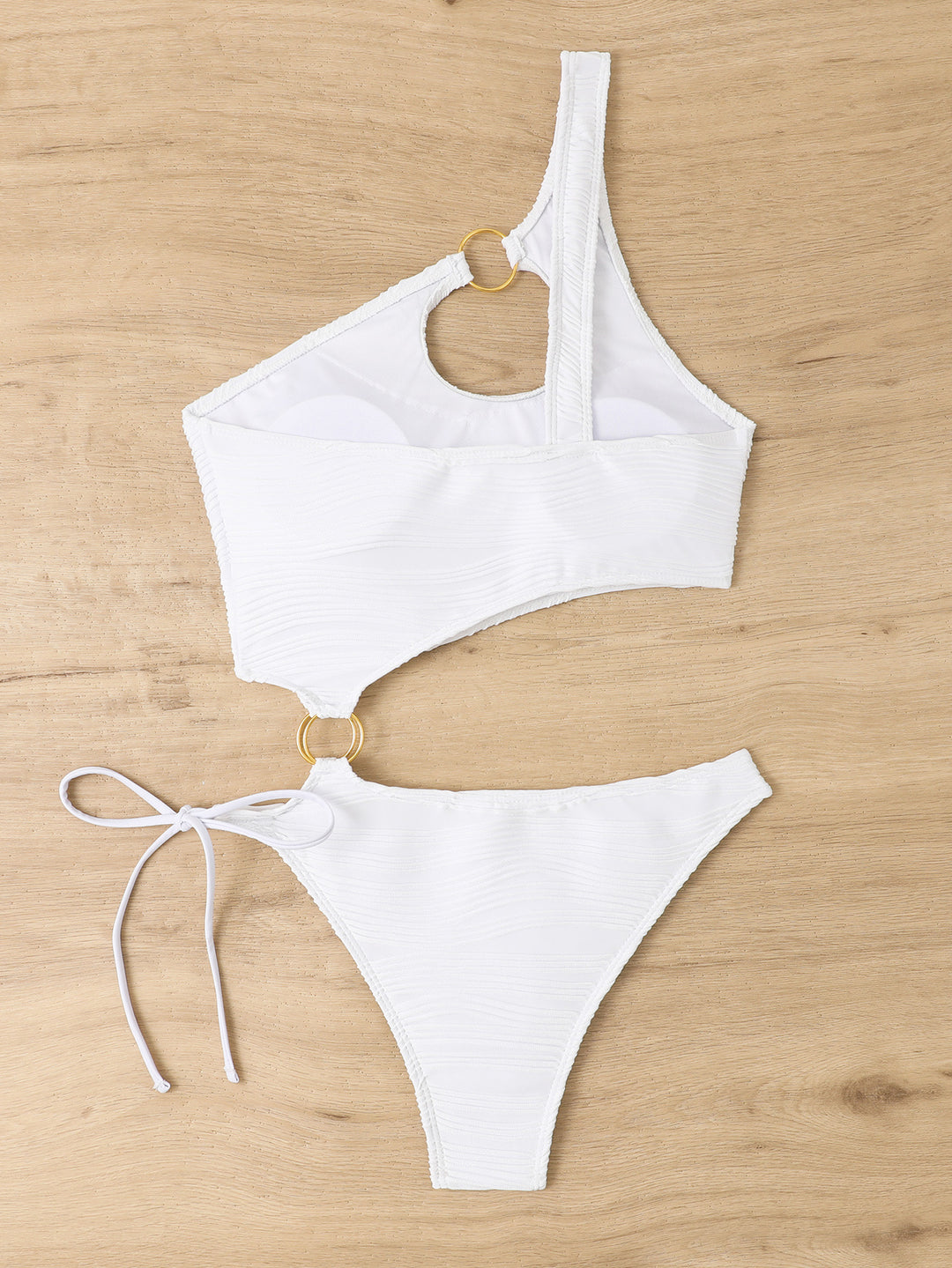 Dame badedragt med asymmetrisk cut-out og gyldne accenter Skovae