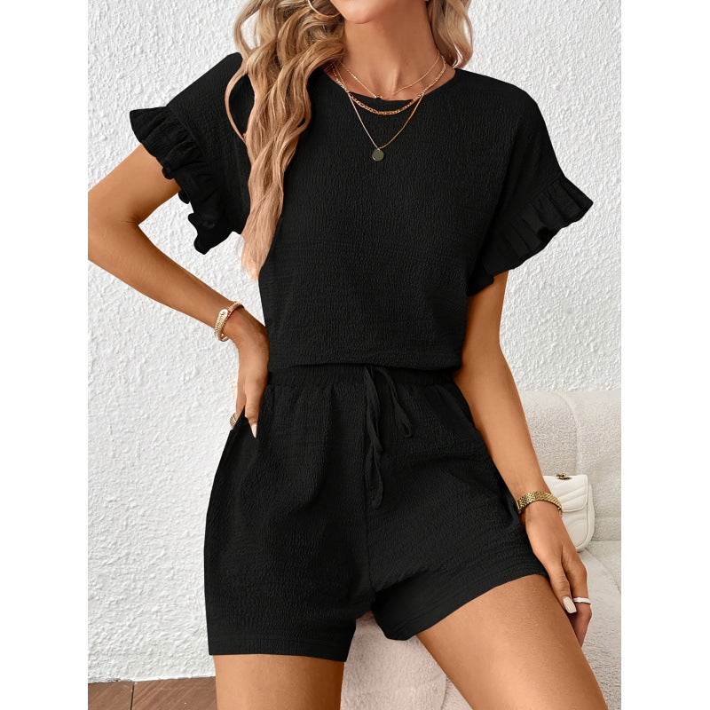 Dame kortærmet jumpsuit med flæse detaljer og bindebælte Skovae
