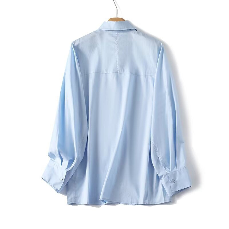 Dame elegant langærmet bluse med moderne detaljer og struktureret stof Skovae