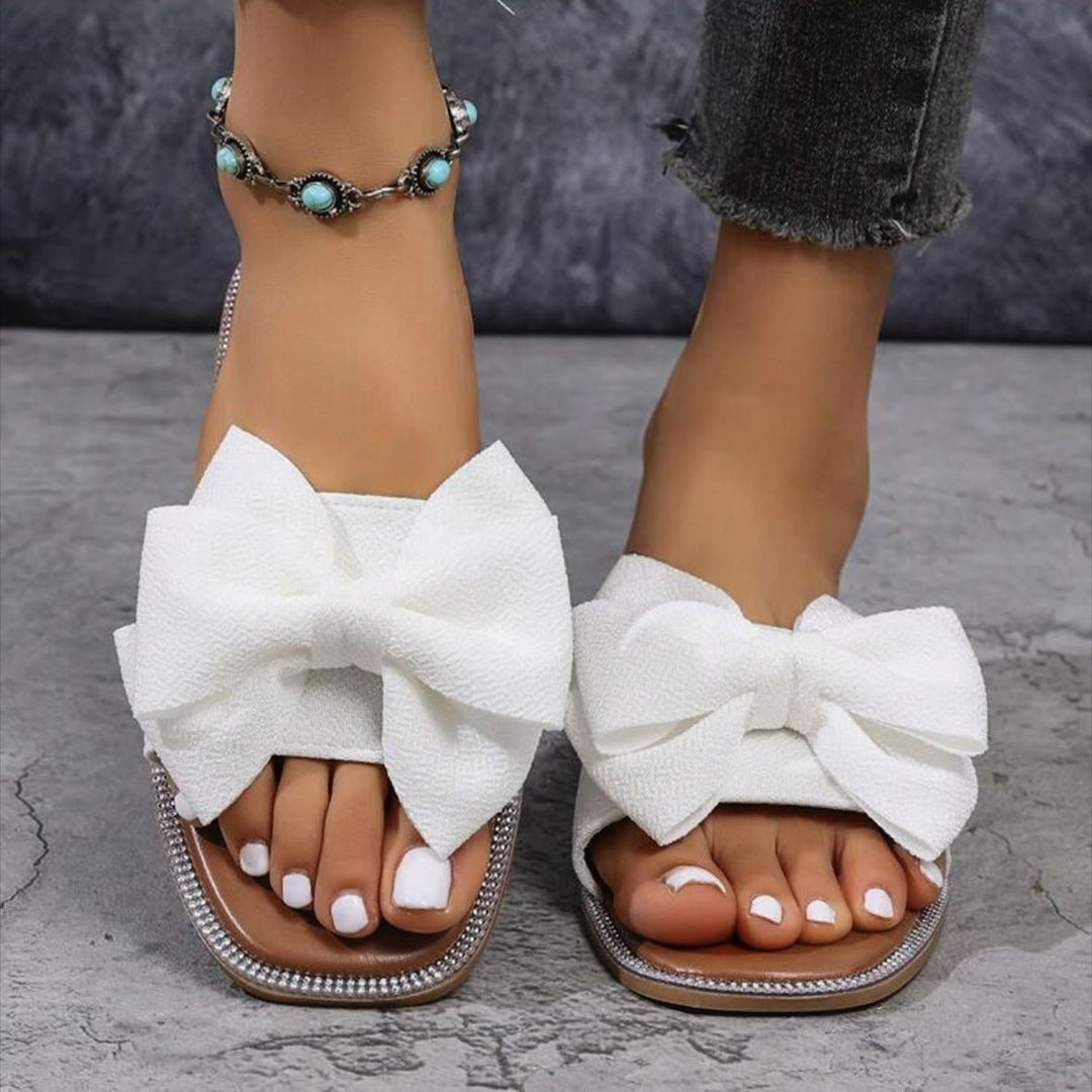 Dame mode slippers med iøjnefaldende sløjfe-design og elegante accenter Stilla