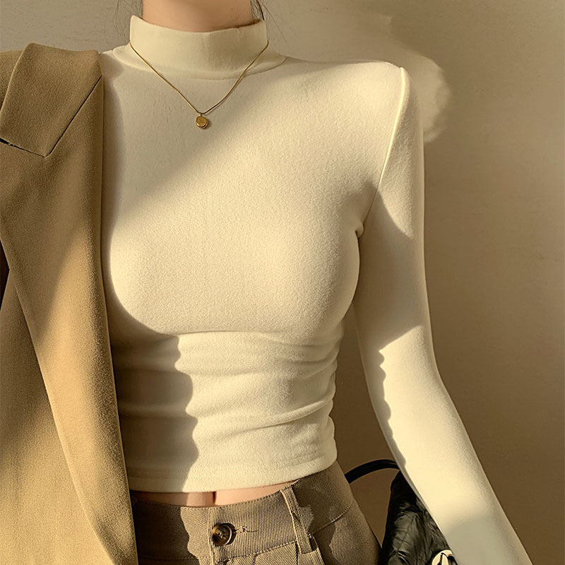 Kvinders langærmet crop top med høj krave og tætsiddende pasform
