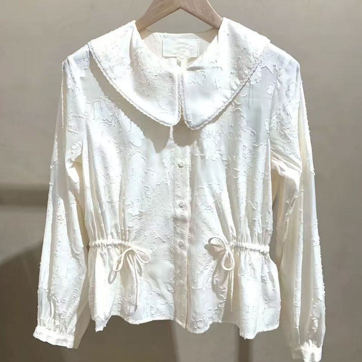 Damebluse med voluminøs krave og elastiske detalje i livet Stilla