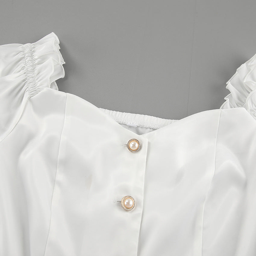 Damebluse med smart skulderfri design og dekorativt sløjfepunkt Stilla