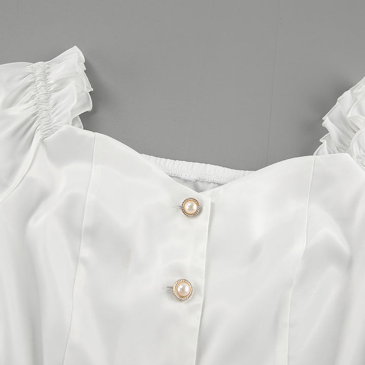 Damebluse med smart skulderfri design og dekorativt sløjfepunkt Stilla