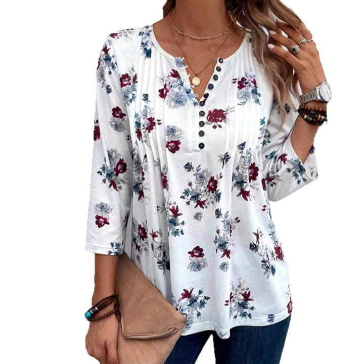 Damebluse med florale accenter og knapper Stilla