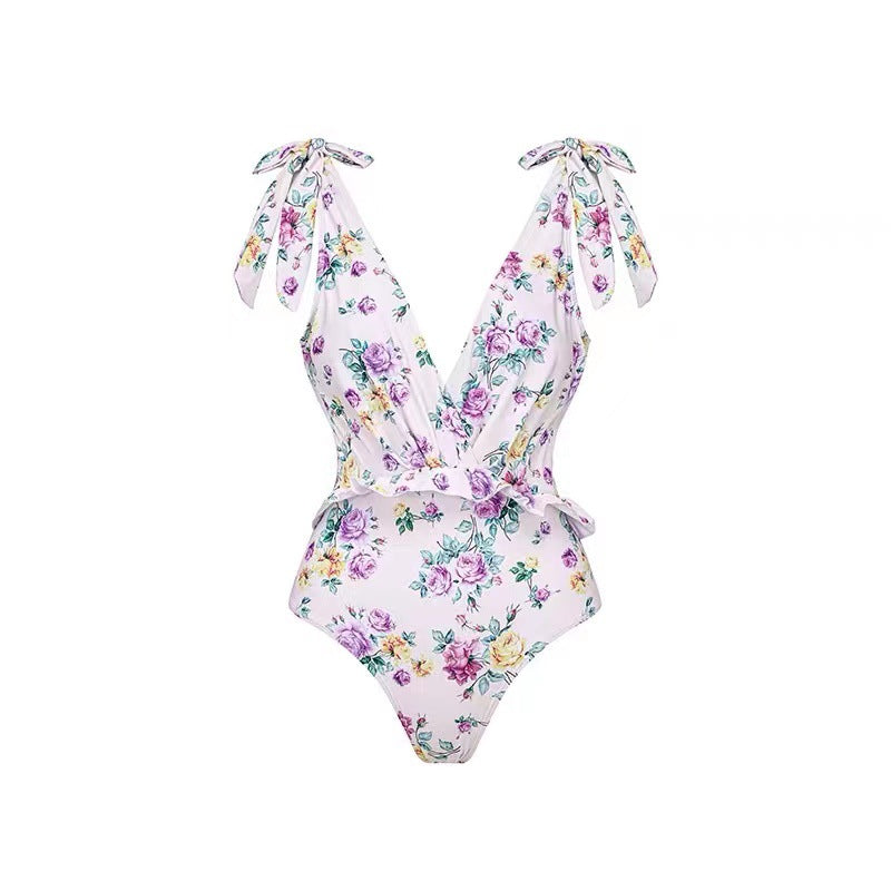 Dame heldragt badedragt med floralsk design og elegant omslagsskørt Stilla