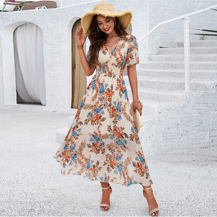 Dame Maxi-kjole med blomsterdesign og svingende kant Stilla
