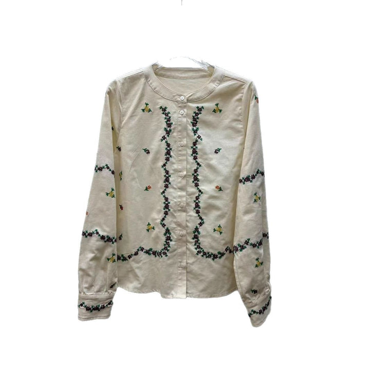 Damebluse med blomsterbroderier og elegant V-udskæring Stilla