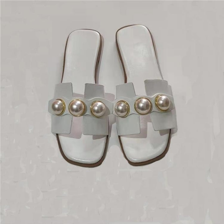 Dame pantoletten med elegant perle-design og moderne rem Stilla