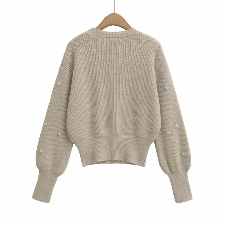 Dame modisk strikpullover med elegante perledetaljer Stilla