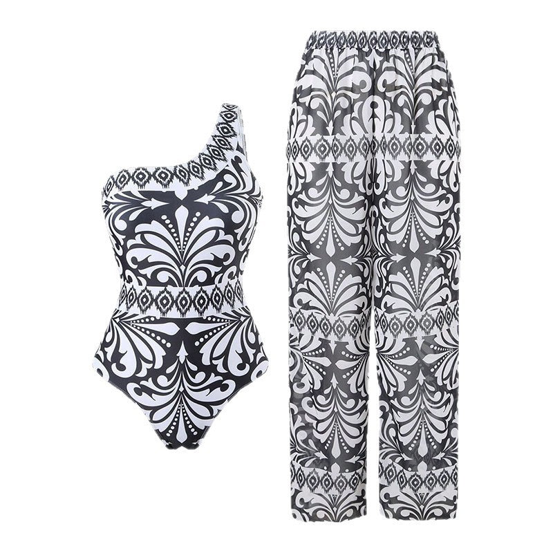 Dame one-piece badedragt med elegant asymmetrisk design og matchende bukser Skovae