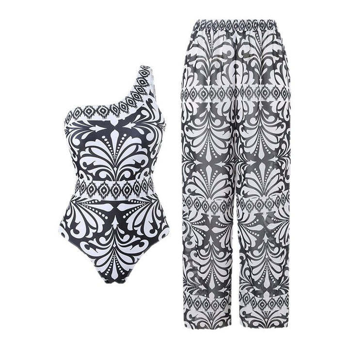 Dame one-piece badedragt med elegant asymmetrisk design og matchende bukser Skovae