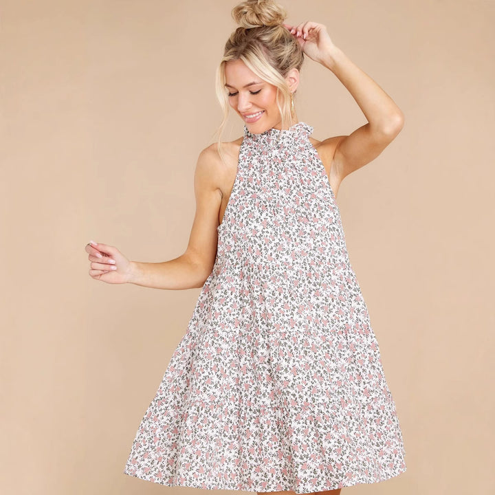 Women's halter dress with playful floral design and ruffle details