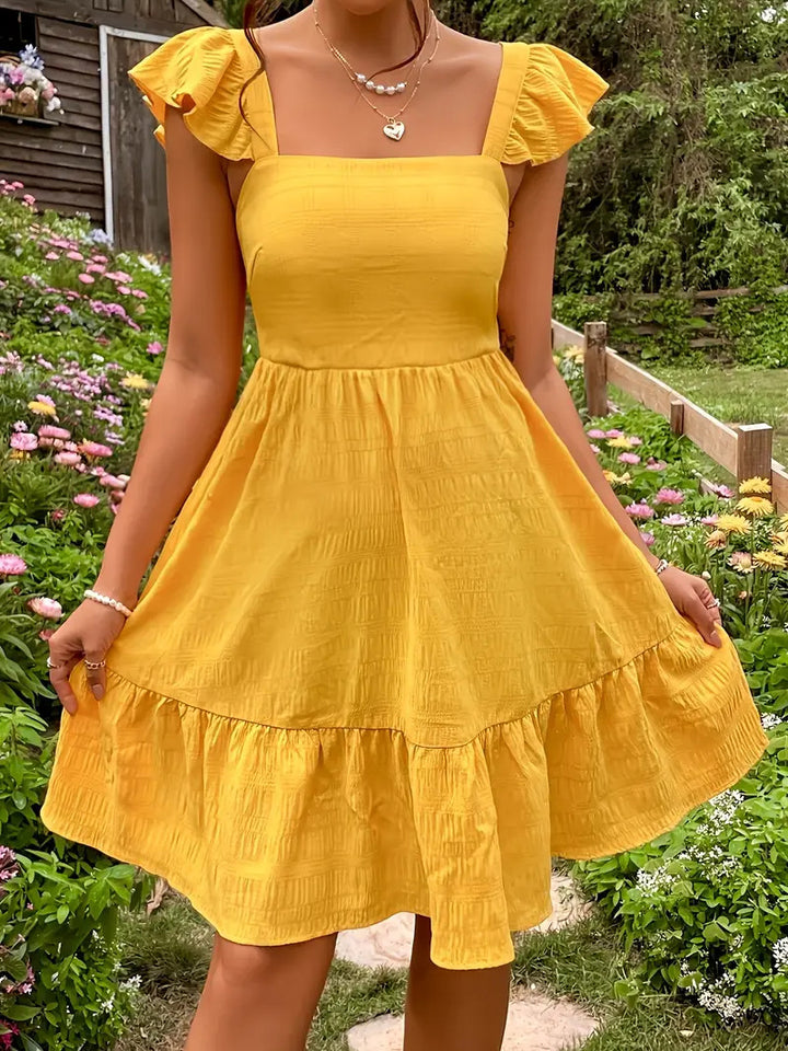 Dame sommerlig flatterkjole med ruffle-detaljer og åben ryg Stilla