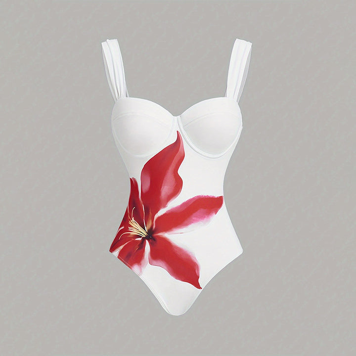 Dame one-piece badedragt med elegant blomsterapplikation og draperet skørt Skovae