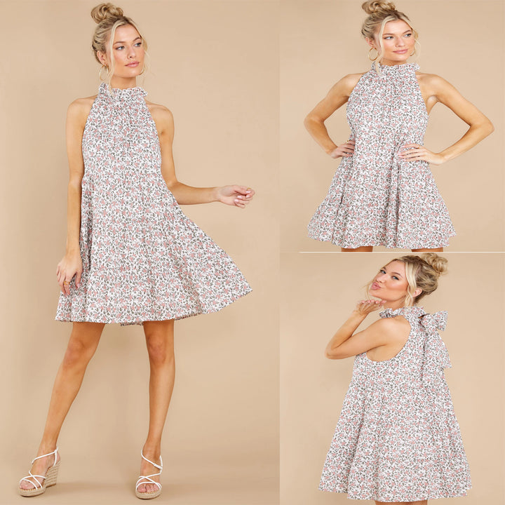 Women's halter dress with playful floral design and ruffle details