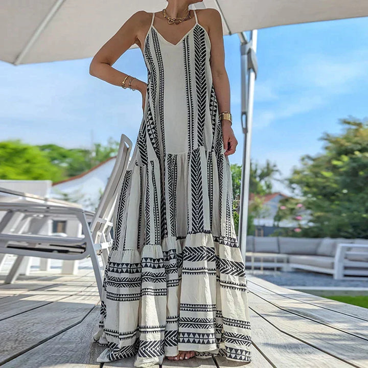 Stilla | Elegante, Ærmeløs Kjole Med Flæser Og Afslappet Print